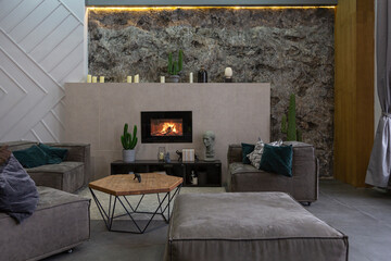 modern studio interior with decorative stone walls in grey. stone wood, tiles and led lighting in...