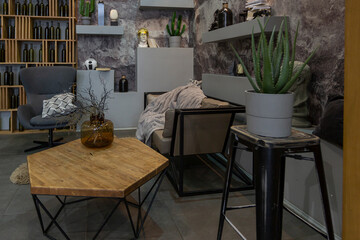 modern sitting place interior design with decorative stone walls in grey. stone wood, tiles and led lighting in the design of the room.