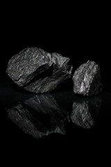 Mineral carbon. A desktop picture. Black rocks on a dark background. A wallpaper.
