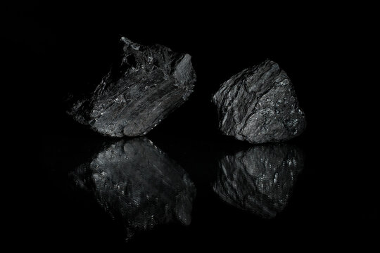 Mineral carbon. A desktop picture. Relief stones with reflection. Photo for a desktop and home screen . 
