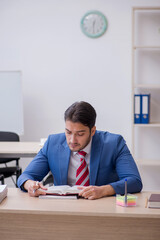 Young attractive employee working in the office