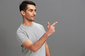 handsome man fun gray t-shirt hand gesture isolated background