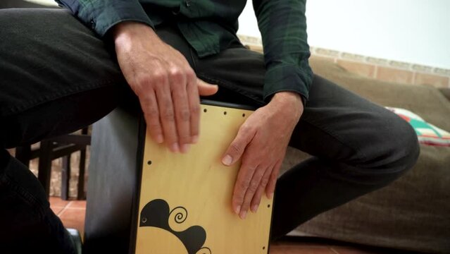 Male hands playing a cajon flamenco