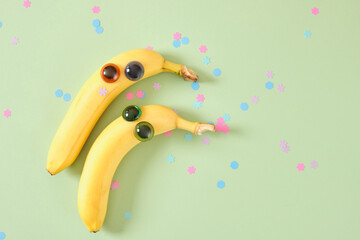 two banana face with eyes, cheerful faces made of plastic doll eyes and fresh yellow bananas
