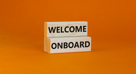 Welcome onboard symbol. Concept words Welcome onboard on wooden blocks on a beautiful orange table...