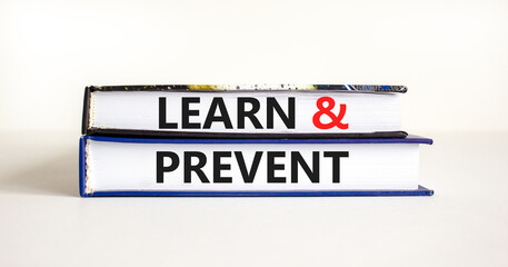 Learn and prevent symbol. Concept words Learn and prevent on books on a beautiful white table white background. Business learning and learn and prevent concept, copy space.