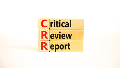 CRR critical review report symbol. Concept words CRR critical review report on wooden blocks on a beautiful white table, white background. Business and CRR critical review report concept. Copy space.