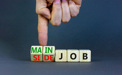 Extra or side job symbol. Businessman turns wooden cubes and changes concept words Side job to Main...
