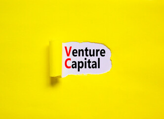 VC venture capital abbraviation symbol. Concept words VC venture capital on yellow paper on a beautiful yellow table white background, copy space. Business and VC venture capital concept.