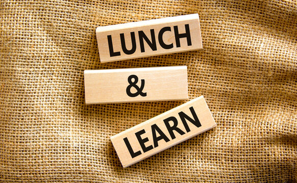 Lunch and learn symbol. Concept words Lunch and learn on wooden blocks. Beautiful canvas table canvas background. Copy space. Business, educational and lunch and learn concept.