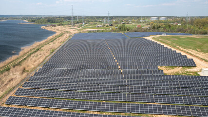 Field with Array of Solar Panels Generating Renewable Electric Power