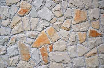  Background of decorative broken stones in beige and gray colors. Seamless pattern wall background.Close up photo 