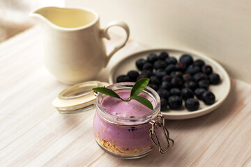 Oat flakes granola or muesli with homemade yogurt smoothie, fresh blueberry and ceramic jug milk