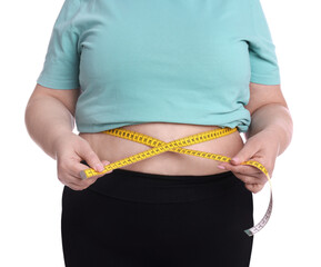 Overweight woman measuring waist with tape on white background, closeup