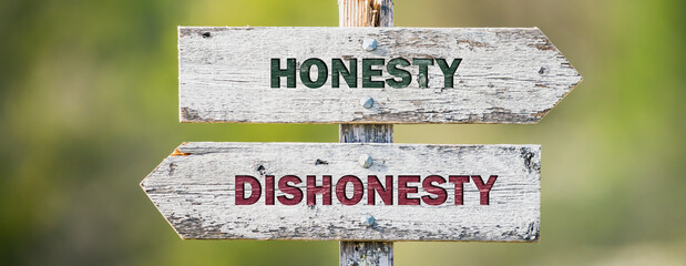 opposite signs on wooden signpost with the text quote honesty dishonesty engraved. Web banner...
