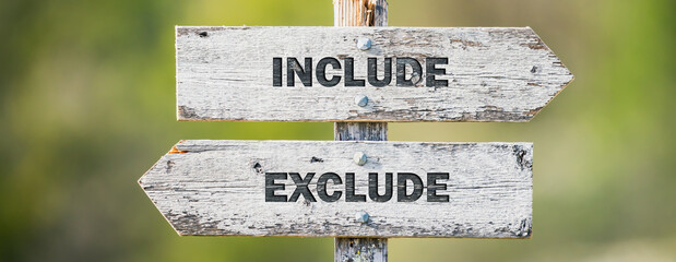 opposite signs on wooden signpost with the text quote include exclude engraved. Web banner format.