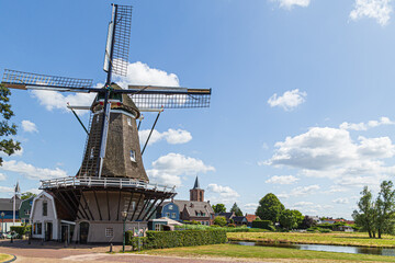 Dutch windmill in the fishing village of Bunschoten in the Netherlands. - obrazy, fototapety, plakaty