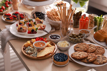 Dishes with different food on table indoors. Luxury brunch