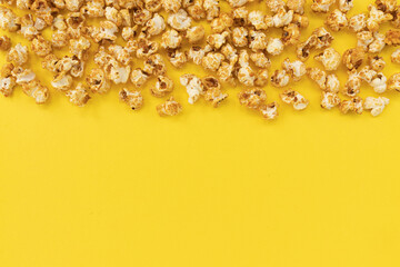 caramel popcorn on yellow background, sweet snacks