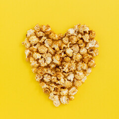 caramel popcorn on yellow close up, sweet snacks