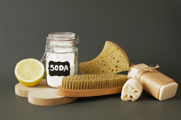 non-toxic home cleaning products on a wooden podium, lemon, soda and an eco-friendly cleaning tool