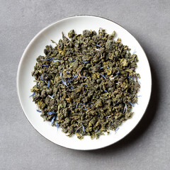 Dried oolong tea and flowers in a small bowl top view