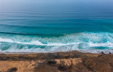 Aerial view about beautiful seashore with waves and rocks. Turquoise water, Atlantic ocean the surfers paradise.