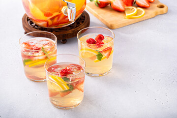 Summer sangria punch in a pitcher and glasses
