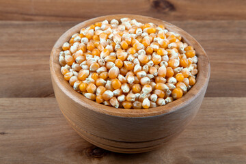 Dry corn seeds full of wooden bowl