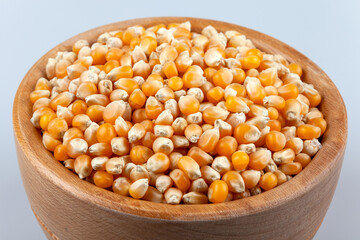 Dry corn seeds in wooden bowl,top view