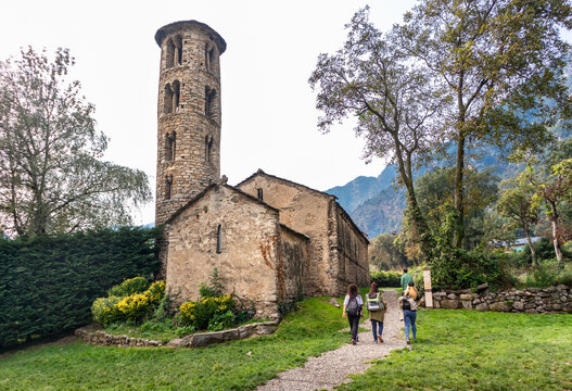 Tourists visiting Església de Santa Coloma, Andorra's oldest church, romanesque style, path leading towards the entrance