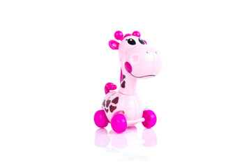 Pink toys giraffe on the white background