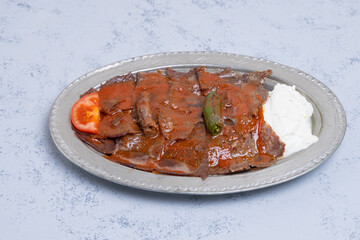 İskender Kebap as a traditional meat food of turkish cuisine with sauce yogurt and butter