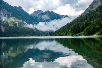 Fototapeta na wymiar Prague wild lake. Mountain lake in Italy. Italian Alps. Mountain panorama South Tyrol, Northern Italy. 