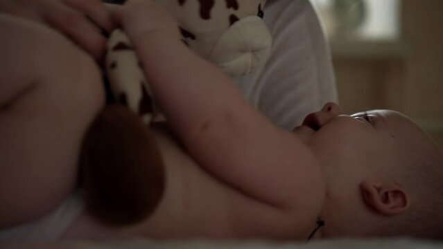 Newborn Baby With Young Mom look Into Each Other Eye. Cute Smiling Teethless Kid Face Portrait. Woman Kissing With Child Look At Camera. Infant, Mother Day, Childbirth, Beginning, Relationship Concept