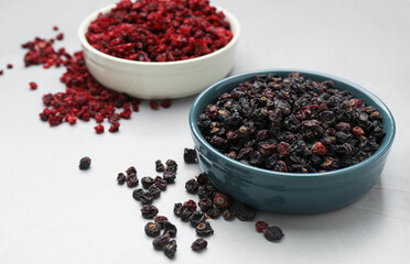 Dried black and red currant berries on light table
