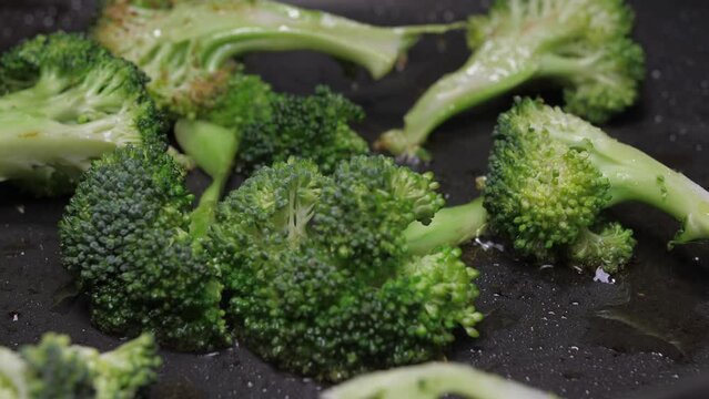 frying broccoli on oil fry pan 4k