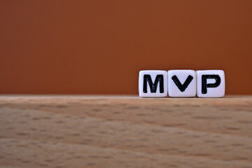 Word cubes lined up with the letters MVP written on it. It is an abbreviation for Minimum Viable...