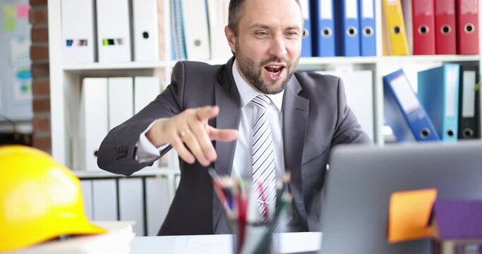 Male contractor builder greets a client on video call