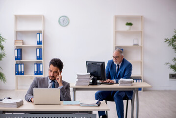 Two male colleagues working in the office