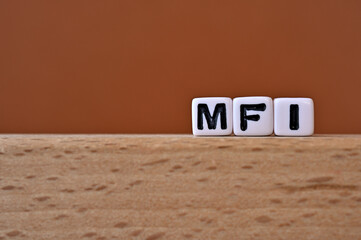 Word cubes lined up with the letters MFI written on it. It is an abbreviation for Mobile First...