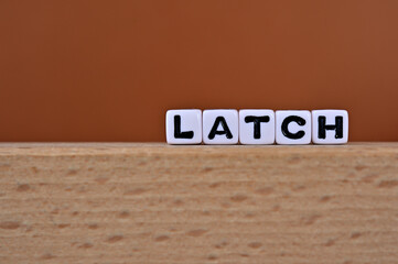Word cubes lined up with the letters LATCH written on it. It is an abbreviation for Location,...