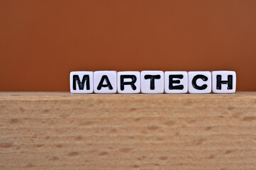Word cubes lined up with the letters MARTECH written on it. It is an abbreviation for Marketing and Technology. Copy space available.