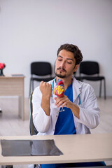 Fototapeta premium Young male doctor cardiologist working in the clinic