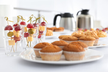 Table with different delicious snacks indoors. Coffee break