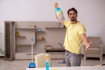 Young man doing housework at home