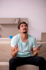 Young man watching tv at home