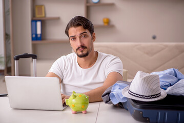 Fototapeta premium Young man preparing for trip at home