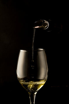 Wine glass with wine dispenser filling the glass