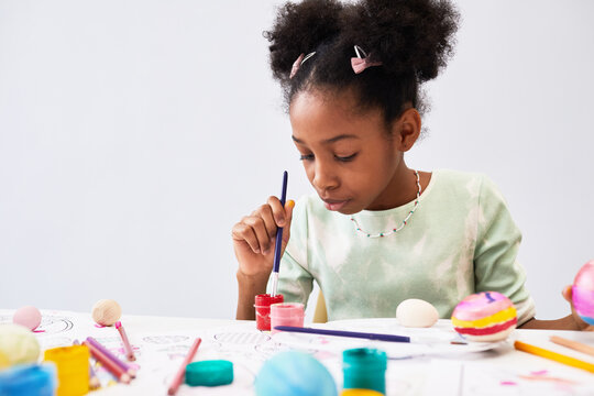 Minimal portrait of cute black girl enjoying art and craft class on Easter, copy space